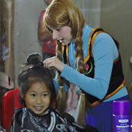 Little Girl Getting Her Hair Fixed for the Party